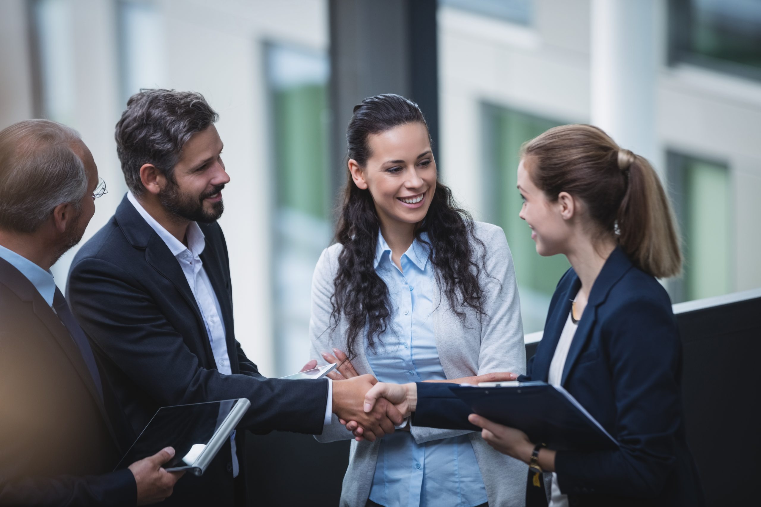 Group of businesspeople having a discussion near staircase in office Group of businesspeople having a discussion near staircase in office